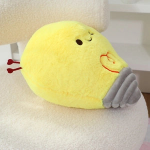 Detail of cartoon light bulb plush toy with soft yellow faux fur on a white sherpa chair