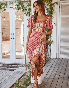 Detail of pink and beige floral maxi dress with bohemian print and side slit design