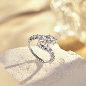 Macro shot of silver multi-layer open ring featuring heart-shaped cubic zirconia crystals