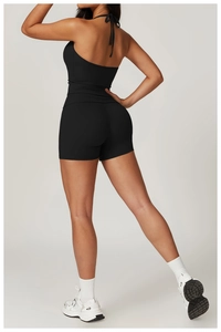 Rear view of black halter-neck yoga set showing slim-fit open-back top and fitness shorts