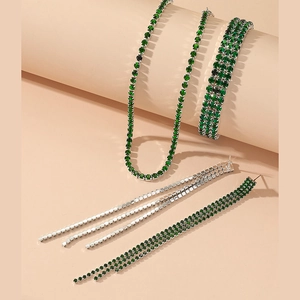 Detail view of emerald green rhinestone jewelry set including necklace, bracelet and earrings