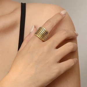 Detailed close-up of 18K gold plated stainless steel ring with vertical grid textures