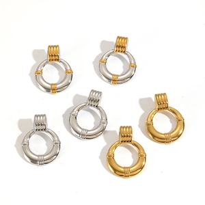 Textured stainless steel hoop earrings set in gold and silver finishes on white background