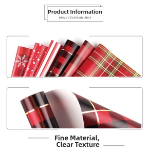 Close-up of red and black checkered and snowflake patterns on holiday gift wrapping paper