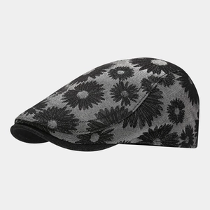 Macro detail of daisy floral print and woven texture on a grey vintage octagonal cap