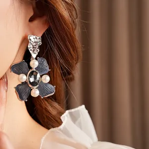 Vintage floral pearl earrings with textured grey petals and central black gemstone