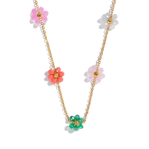 Detail of colorful beaded flower necklace with gold chain in bohemian style