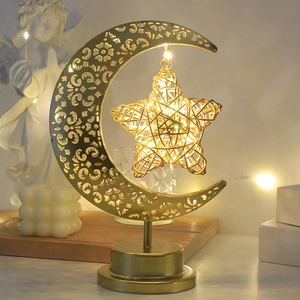 Detail of warm glowing hemp rope moon and star decorative lamp on circular metal base