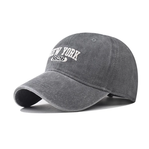 Close-up of white NEW YORK 1625 embroidery on washed grey cotton baseball cap
