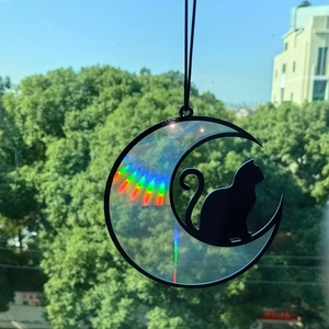 Rainbow suncatcher featuring a black cat on a crescent moon with prism light effect