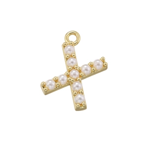 Macro view of 18K gold plated cross pendant with pearl inlay showing metallic luster