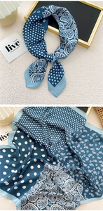 Detailed view of paisley silk scarf texture with blue and white polka dot patterns
