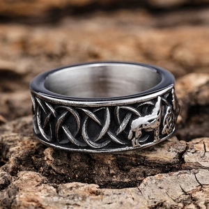 Macro view of Viking wolf relief and Celtic knot patterns on vintage steel ring