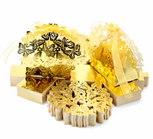 Detailed view of white hollow butterfly candy boxes with metallic finish and gold ribbons