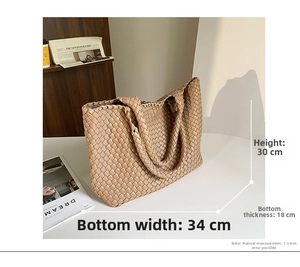 Detail shot of woven leather tote bag showing 30x34x18cm dimensions and spacious design