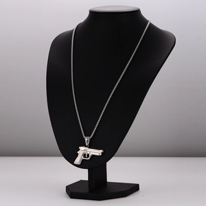 Unique silver stainless steel pistol pendant necklace displayed on a black mannequin