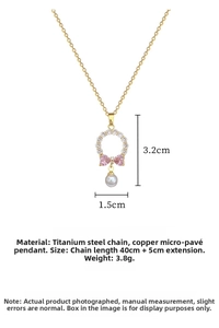 Detail view of titanium steel necklace with bow pendant and pearl drop size 3.2cm