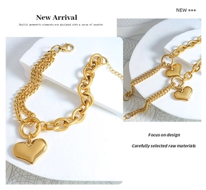 Detail of 18K gold-plated Cuban link heart bracelet showing thick and thin chain textures