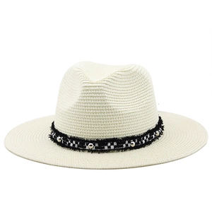 Fashionable beige straw sun hat with checkered ribbon and silver buckle for beach vacation