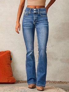 Close-up of high-waisted flared jeans with double button fly and washed denim texture