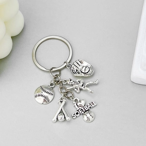 Close-up of silver antique baseball charms with I Love Softball engraving and glove