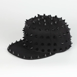 Close-up of black punk hip hop cap with metallic conical studs and adjustable flat brim