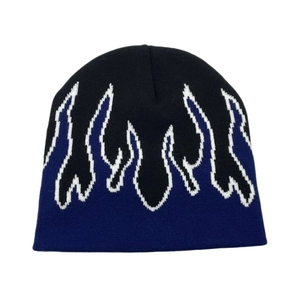 Detailed view of the flame jacquard pattern on black and blue knitted beanie