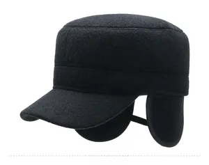 Detail of winter flat top cap with ear protection and silver SPORT metal badge
