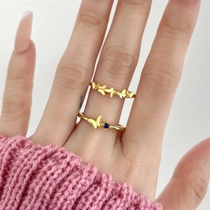 18k gold plated open rings featuring blue zircon and butterfly motifs on model fingers