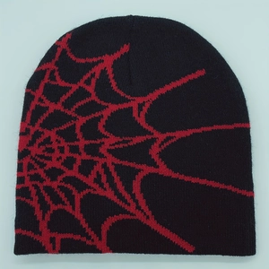 Close-up of spider web pattern on black and red jacquard knitted beanie hat