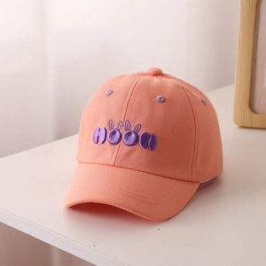 Close-up of orange cotton baseball cap with purple 3D rabbit ear embroidery details
