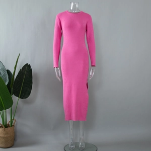 Close-up of bright pink ribbed knit dress detailing round neck and slit hem detail