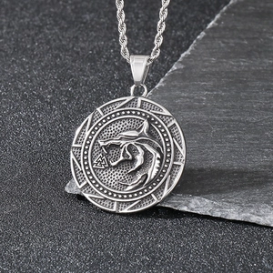 Vintage stainless steel wolf head pendant necklace on stone background for men