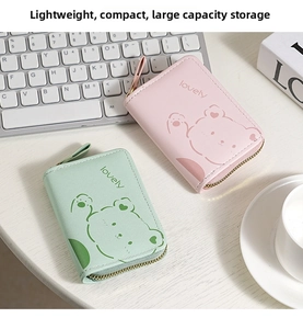 Close-up of pink and mint green organza wallets with bear patterns and gold zipper