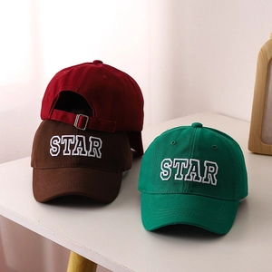 Detail of colorful cotton baseball caps featuring STAR embroidery and metal buckle strap