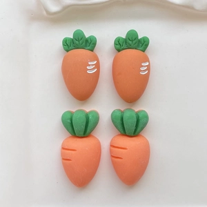 Detailed close-up of orange resin carrot accessories with green leaves for DIY crafts