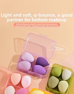 Close-up of multicolored soft makeup sponges in a transparent four-grid storage case