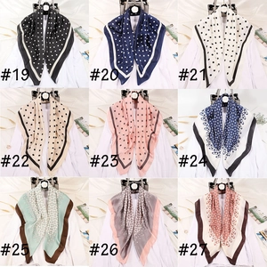 Detailed grid view of assorted satin silk scarves featuring classic polka dots and chain prints