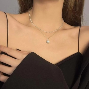 Elegant double-layered gold necklace with white pearls and round pendant for women