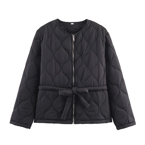 Detail of black diamond-quilted jacket featuring round neck and drawstring waist tie