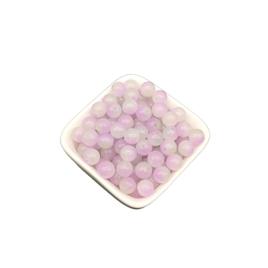 Close-up of 8mm light purple gradient glass beads in a white bowl for DIY jewelry making