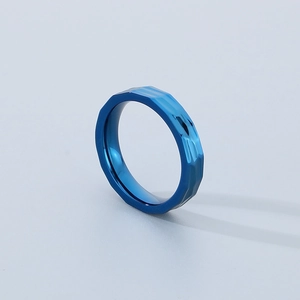 Detailed macro shot of blue titanium steel ring with unique geometric hammered texture