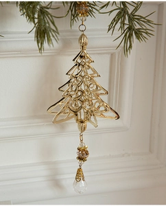 Detailed view of golden iron Christmas tree ornament with beaded crystal pendants