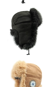 Detail view of winter earflap hats in black and camel with plush lining and chin straps
