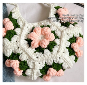 Detailed close-up of handmade 3D crochet puff flower with pearl bead and green leaves