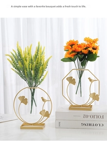 Detail of Nordic gold geometric metal frames with glass tubes and decorative birds