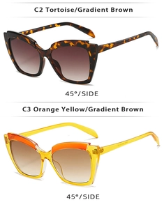 Detail view of tortoiseshell and orange cat eye sunglasses with gradient brown lenses