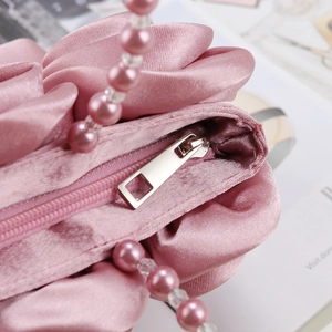 Borsa a mano in raso rosa con trama floreale e manico in eleganti perle rosa