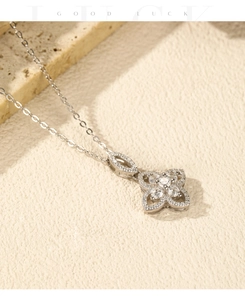 Detail of S925 silver flower necklace with white zircon inlays on stone surface