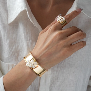 Golden metal jewelry set with pearl flower open cuff bracelet and matching ring for women